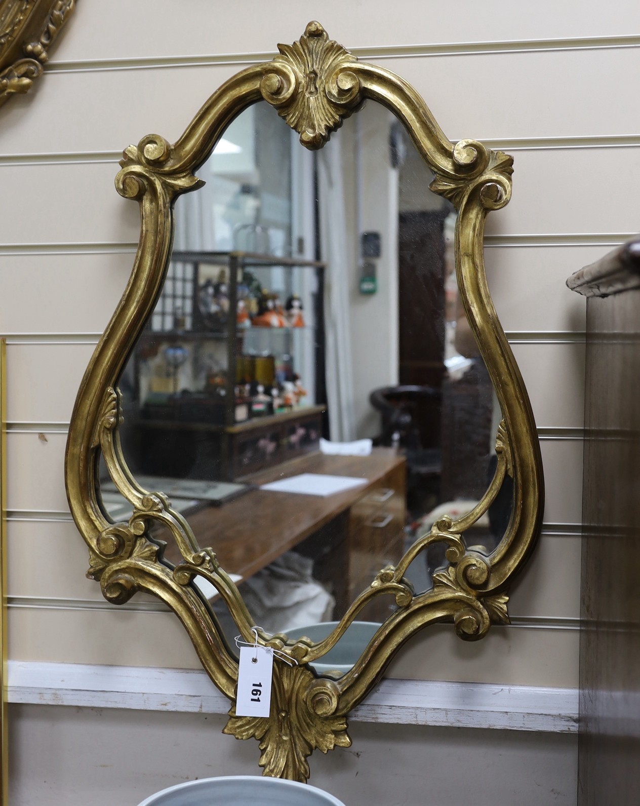 A gilt cartouche shaped mirror, width 51cm, height 80cm